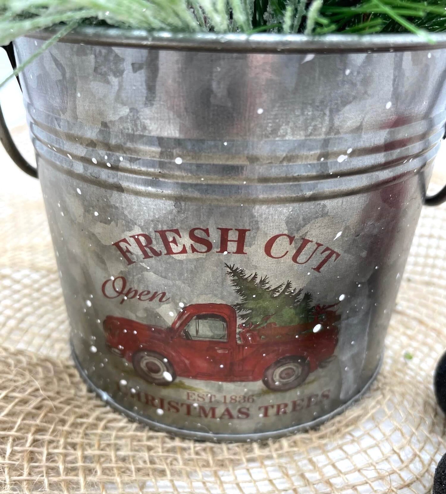 Metal tin with red truck with winer christmas greenery arrangement with red ornaments