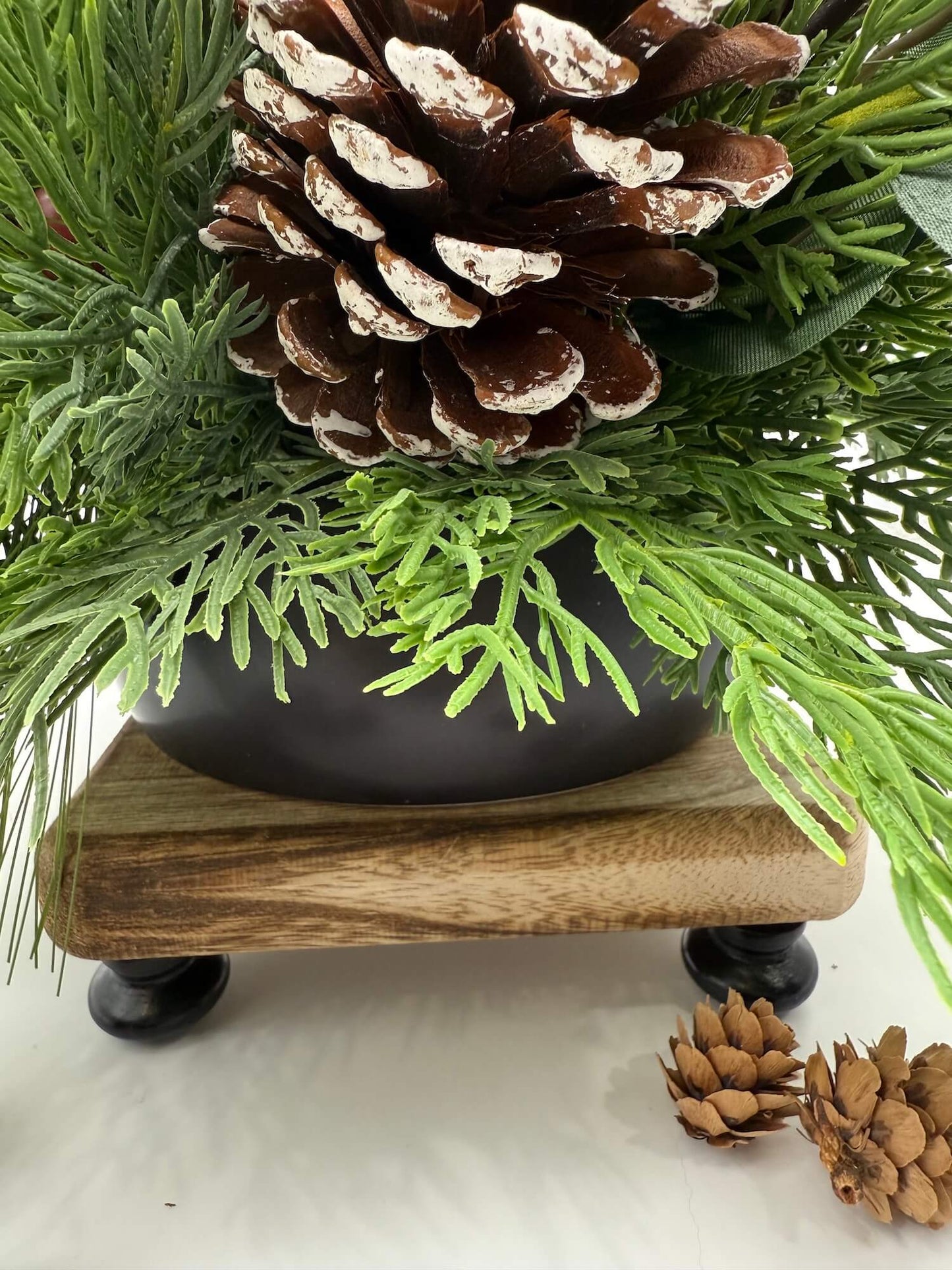 winter arrangement in black ceramic vase