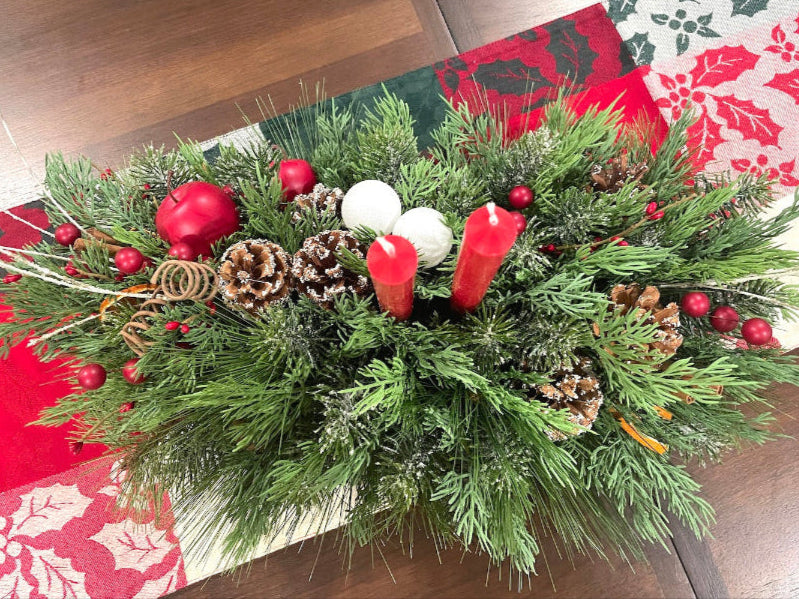 christmas centerpiece with variety of evergreen stems, winter berries, pinecones and candle, large, lush and elegant