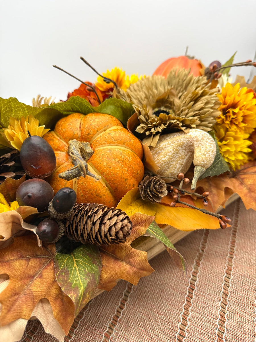 Harvest Centerpiece with fall flowers, pumpkins and berries in wooden long bowl in modern farmhouse style