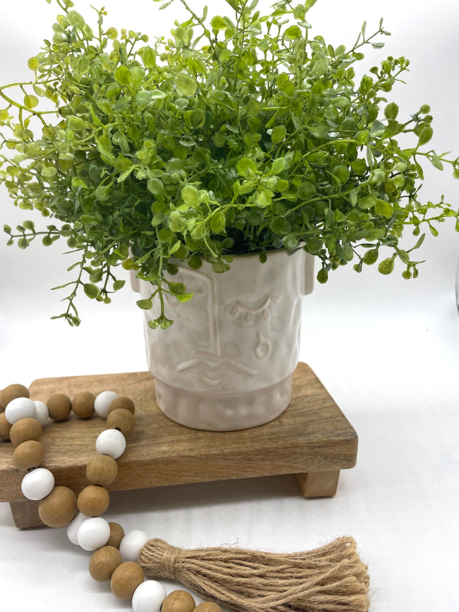 realistic faux greenery in face ceramic white-ish pot vase