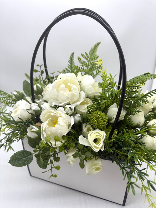 white rosues with vivid greenery bouquet in white gift bag