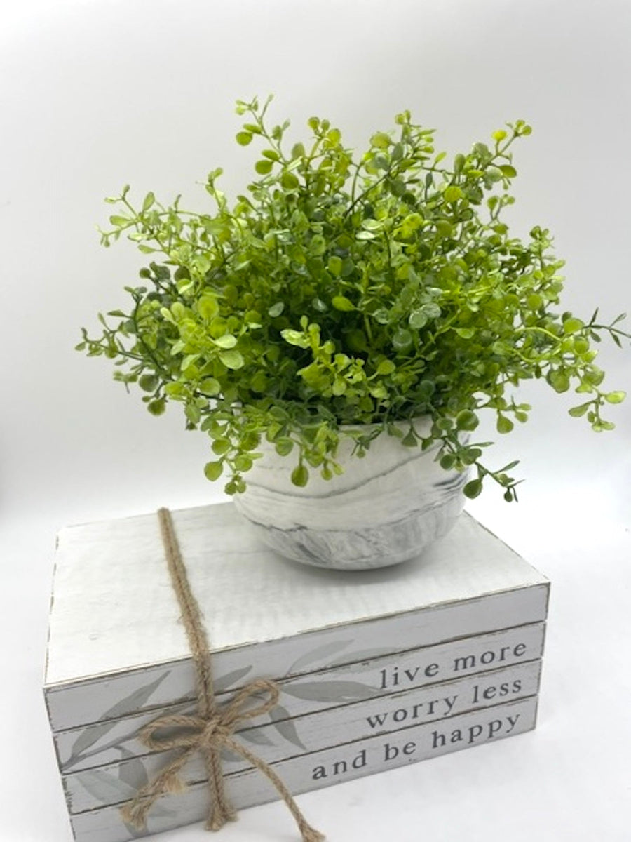 green faux plant in ceramic marble-like vase pot