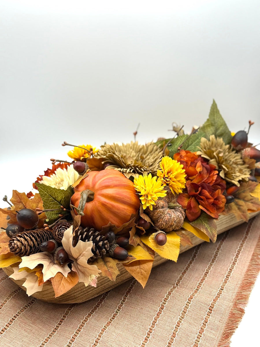 Harvest Centerpiece with fall flowers, pumpkins and berries in wooden long bowl in modern farmhouse style
