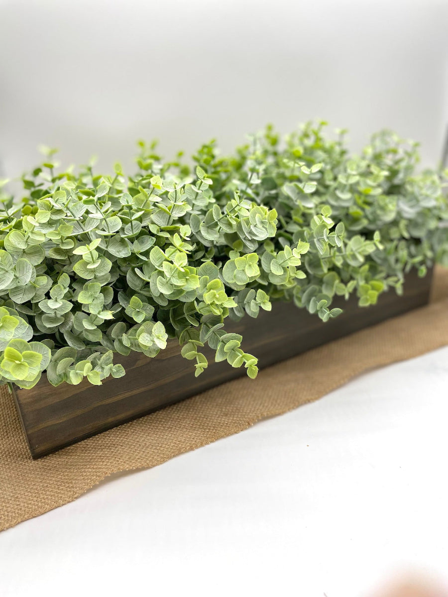 realistic long eucalyptus centerpiece in wooden planter