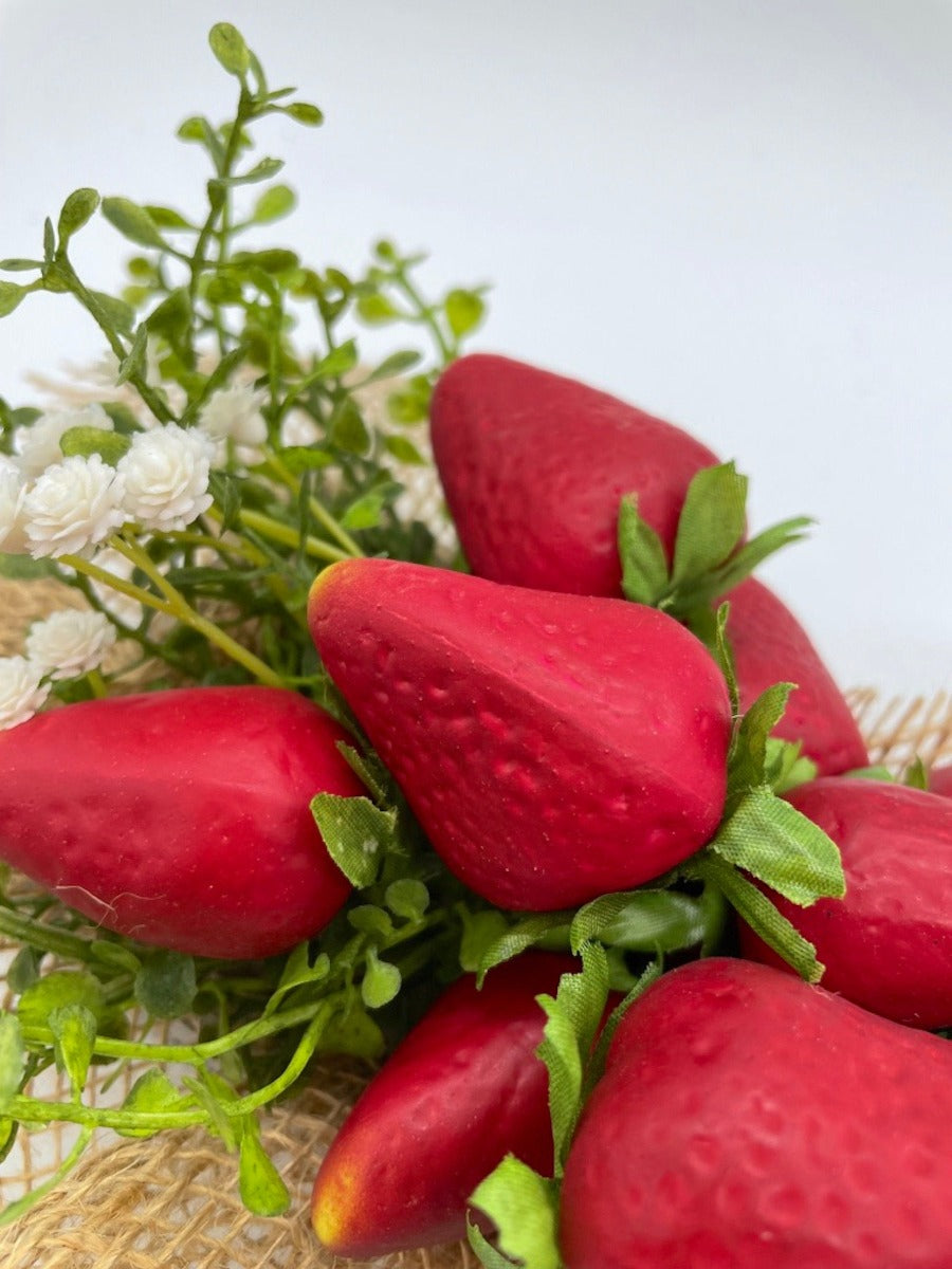 close up for realistic Artificial Strawberry in wooden crate in gray or white decorated with greenery, white flowers and burlap