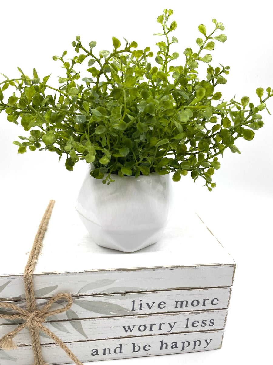 artificial greenery in white geometric vase pot