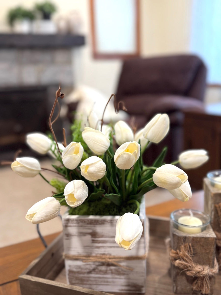 silk white tulips with grapevine and greenery and moss in whitewashed wooden vase