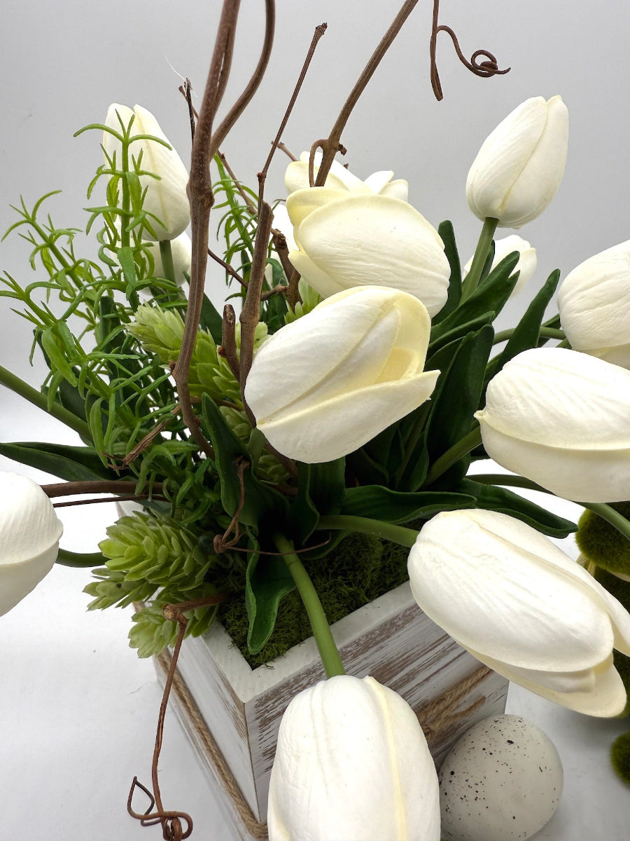 realistic white tulips with spring greenery in white wooden box