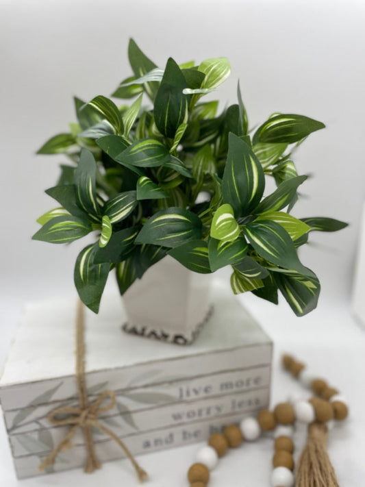 realistic looking silk faux plant with green leaves and white stripes in square ceramic white pot vase