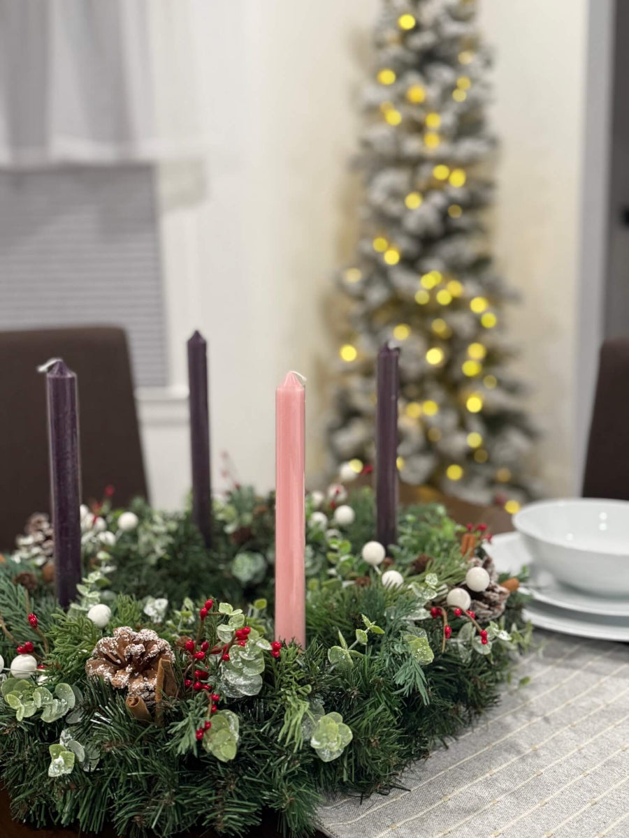 handmade lush elegant evergreen advent wreath with arborvitae and snowy eucalyptus stems decorated with pinecones, red and white berries and cinnamon stick, with four taper candles in purple/pink, red or white perfect for dining table