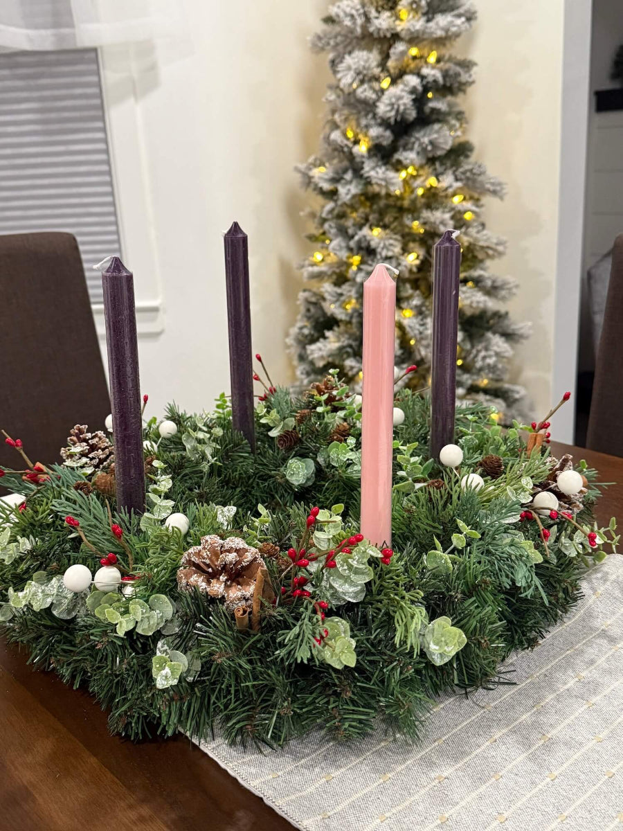handmade lush elegant evergreen advent wreath with arborvitae and snowy eucalyptus stems decorated with pinecones, red and white berries and cinnamon stick, with four taper candles in purple/pink, red or white perfect for dining table