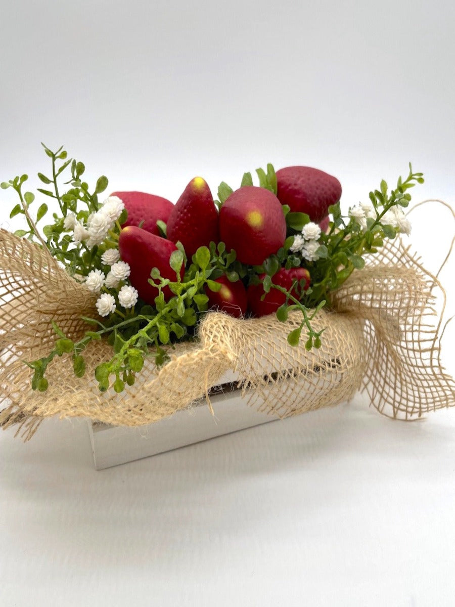 realistic Artificial Strawberry in wooden crate in gray or white decorated with greenery, white flowers and burlap