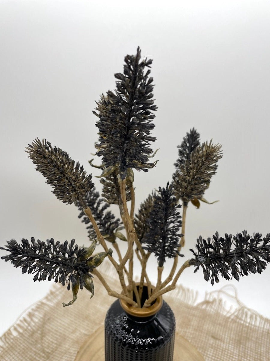 black wheat stems in elegant black ceramic vase
