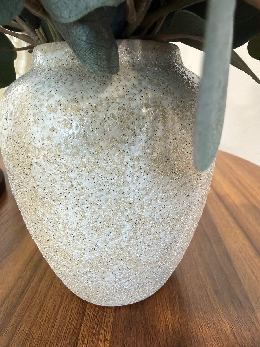 close up for vase of elegant realistic lush silver dollar eucalyptus in stone-like ceramic beige vase