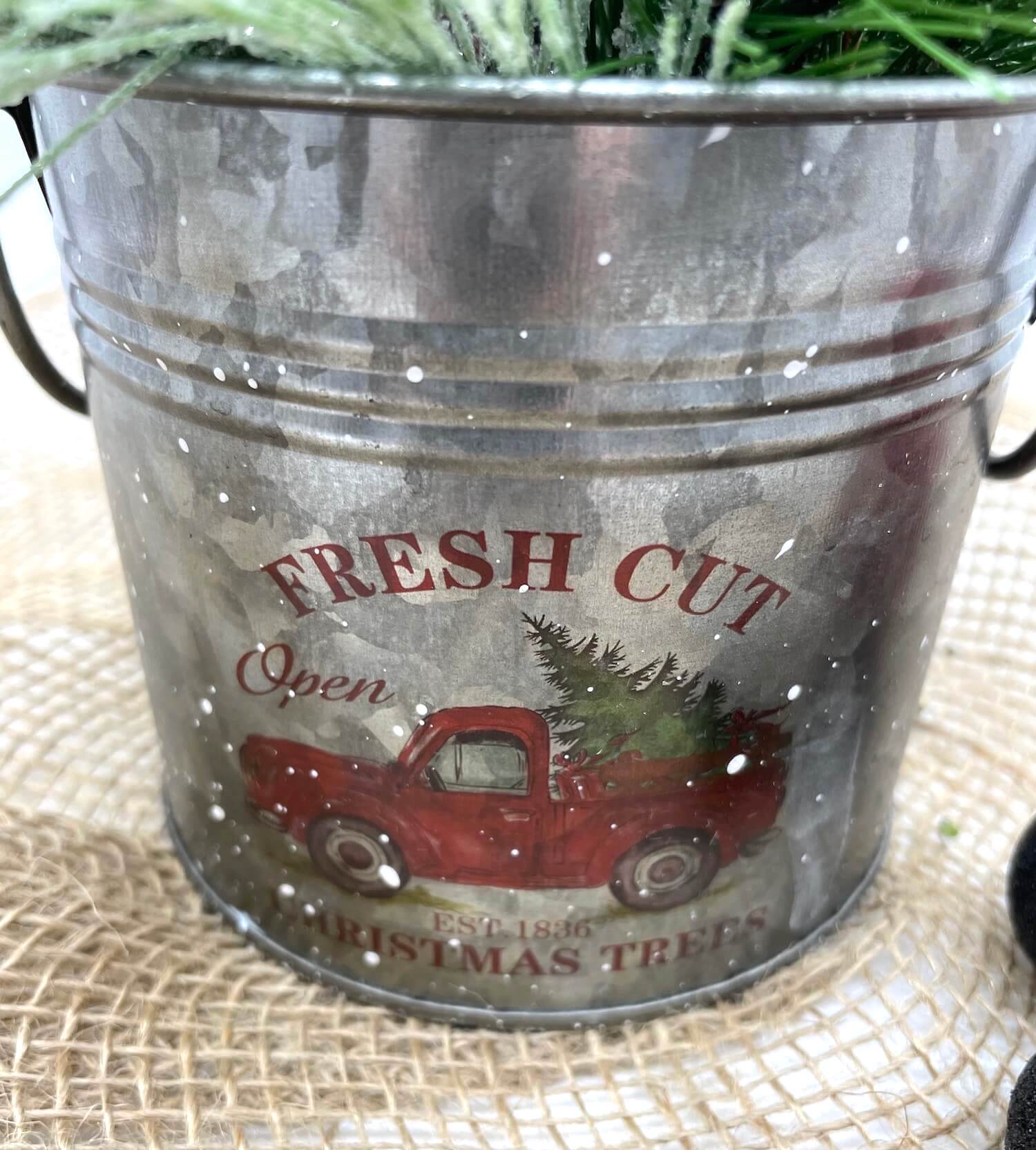 Metal tin with red truck with winer christmas greenery arrangement with red ornaments