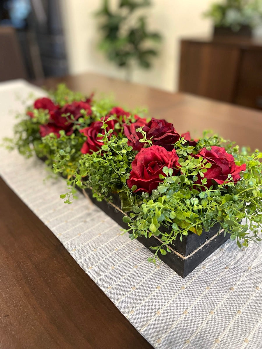 realistic deep red roses and vivid greenery in  wooden planter stained is expresso color
