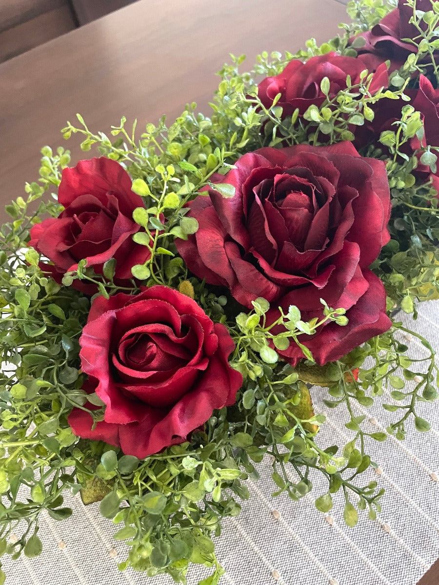 close up for deep red realistic looking roses and vivid greenery