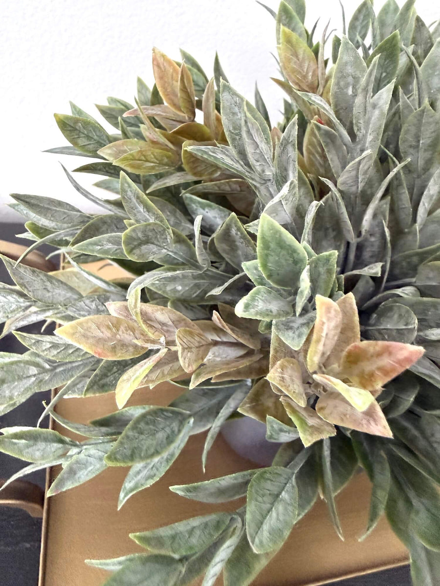 close up for Dusty green faux plant with lush realistic foliage in a black matte geometric ceramic pot, styled for a shelf, desk, countertop, or small space