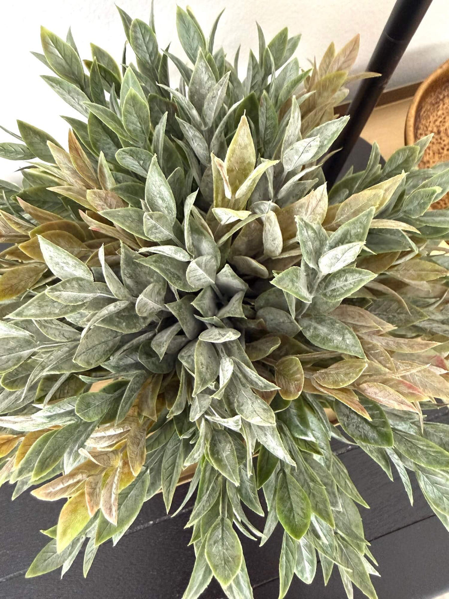view from top Dusty green faux plant with lush realistic foliage in a black matte geometric ceramic pot, styled for a shelf, desk, countertop, or small space