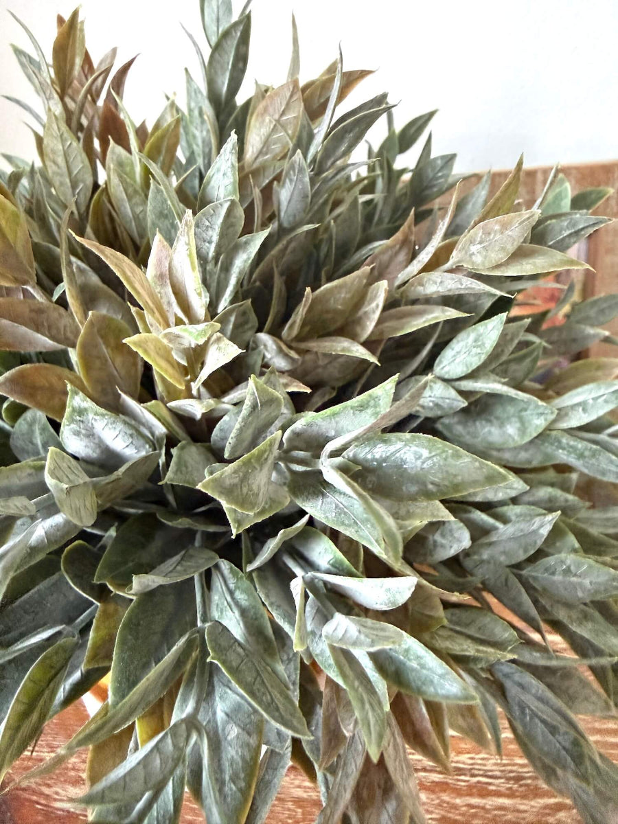 view from top muted dusty green faux plant in yellow ceramic vase for table and shelf