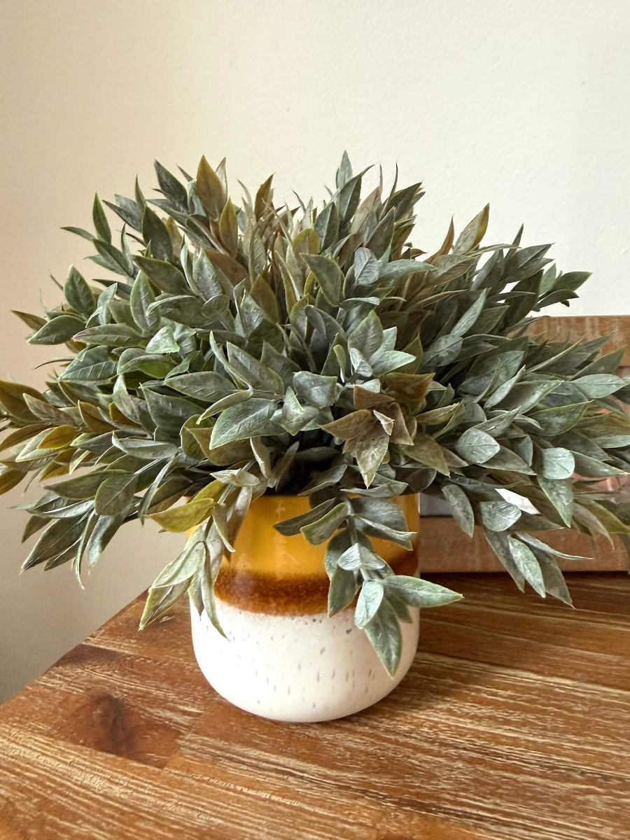 muted dusty green faux plant in yellow ceramic vase for table and shelf