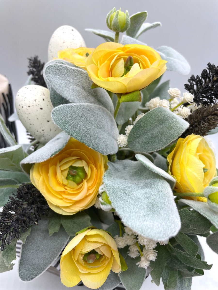 Easter Arrangement with yellow flowers, lambs ears, faux eggs, white flowers