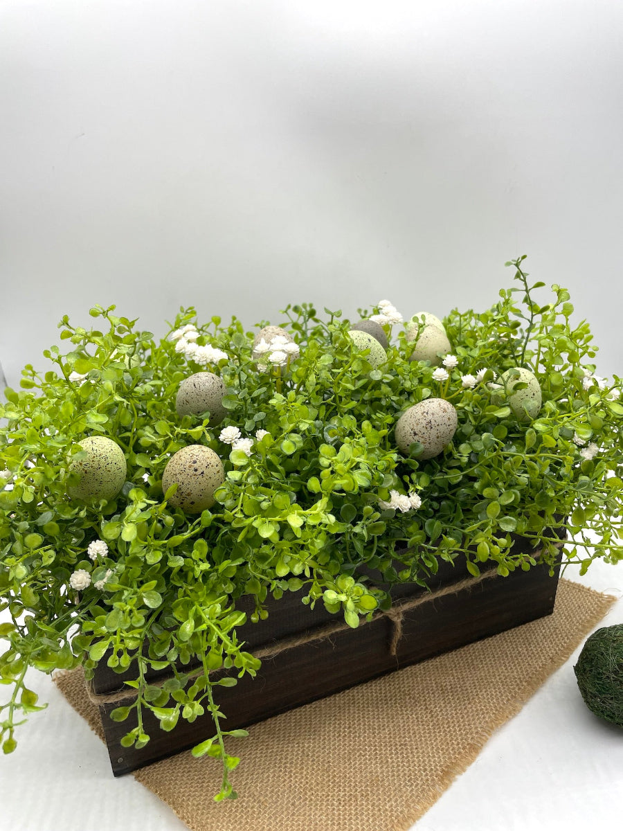 Greenery Centerpiece with faux eggs for Easter in neutral earthy tones