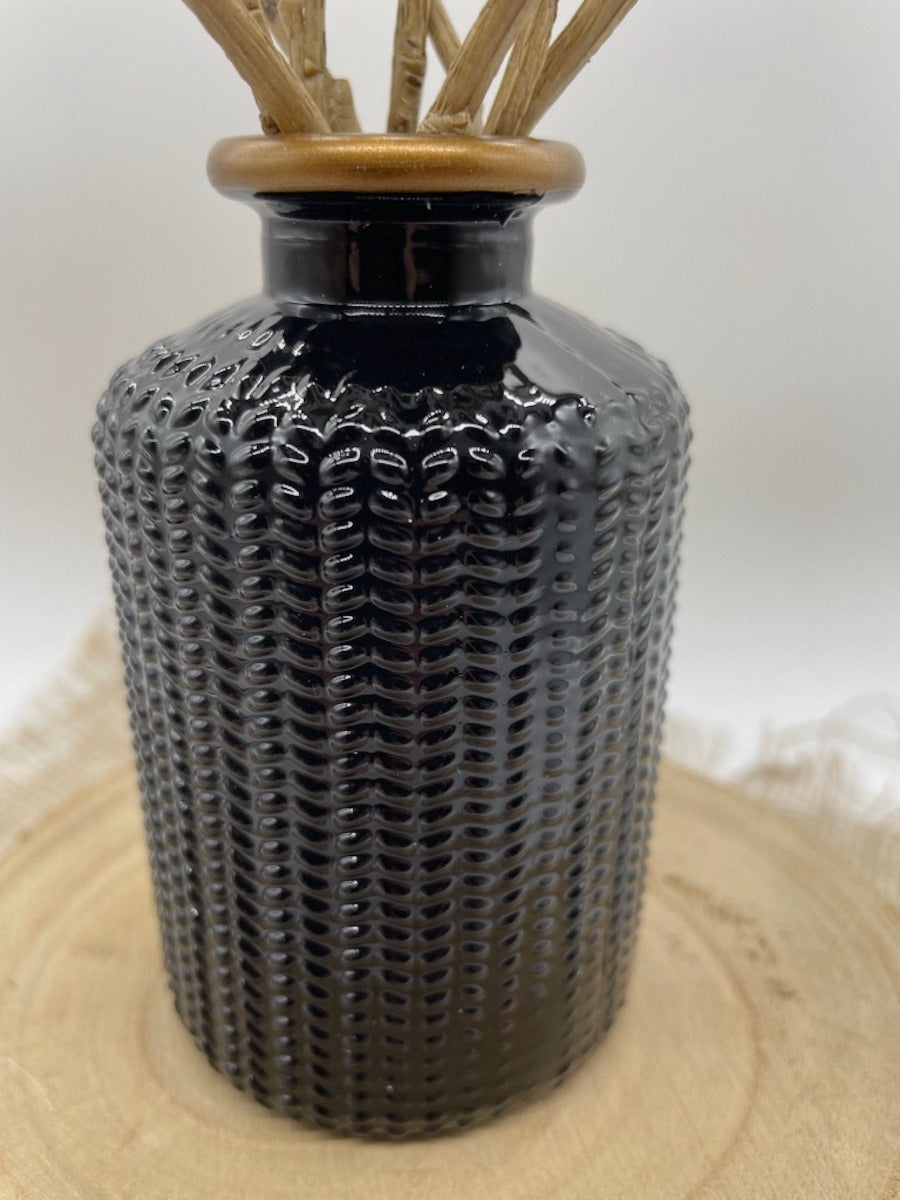 close up for black wheat stems in elegant black ceramic vase