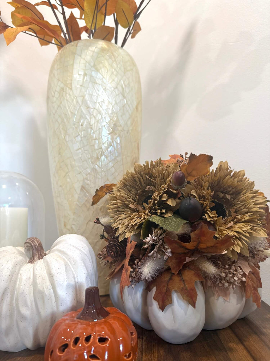 elegant fall centerpiece on white wooden planter