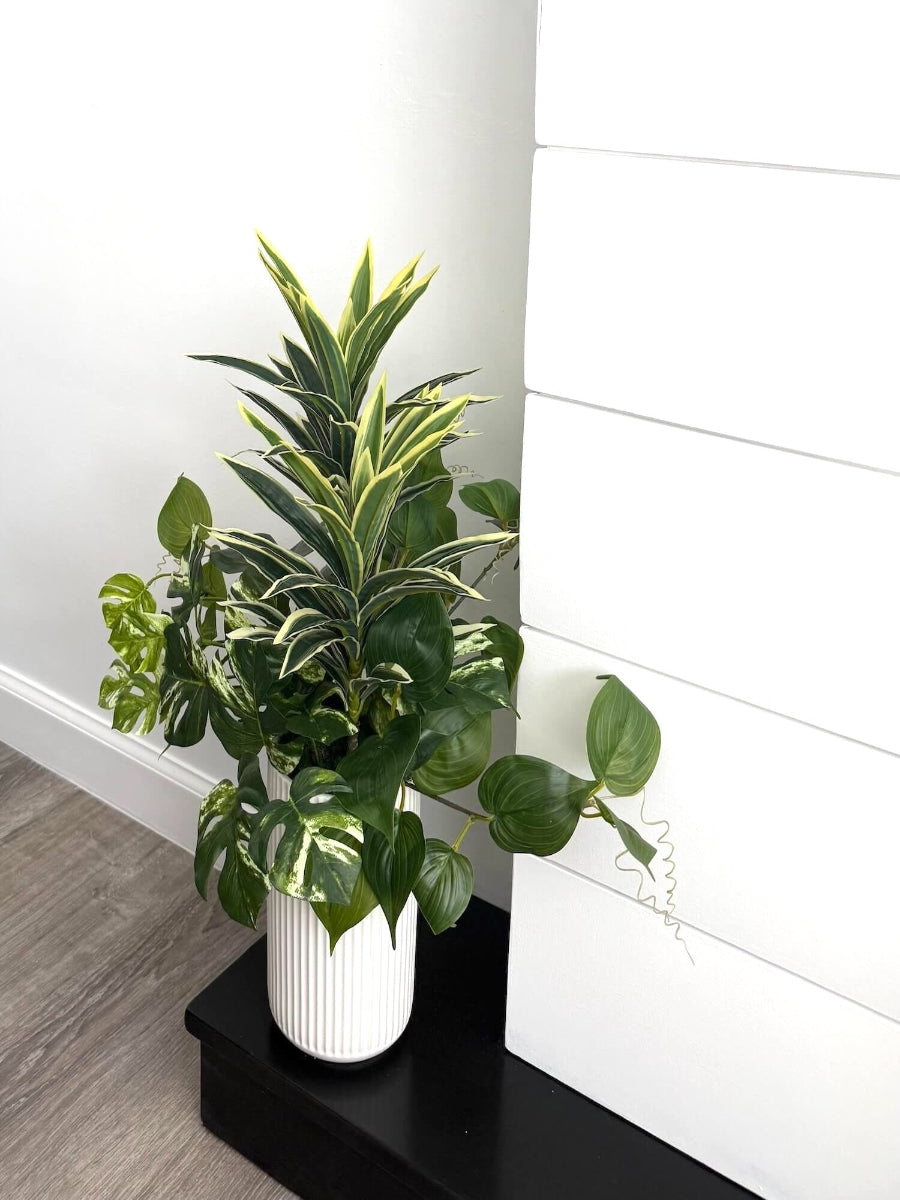 tall arrangement, mix of 3 realistic looking vivid green faux plants with leaves in green and green-white, placed in tall white ceramic textured pot vase