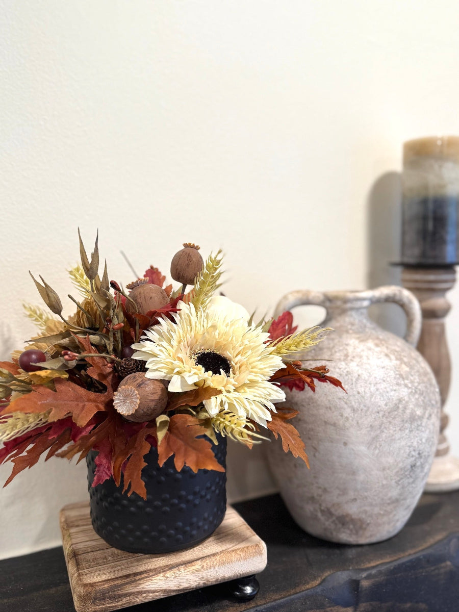 Decorative fall arrangement with flowers and leaves in a black pot unique and handcrafted
