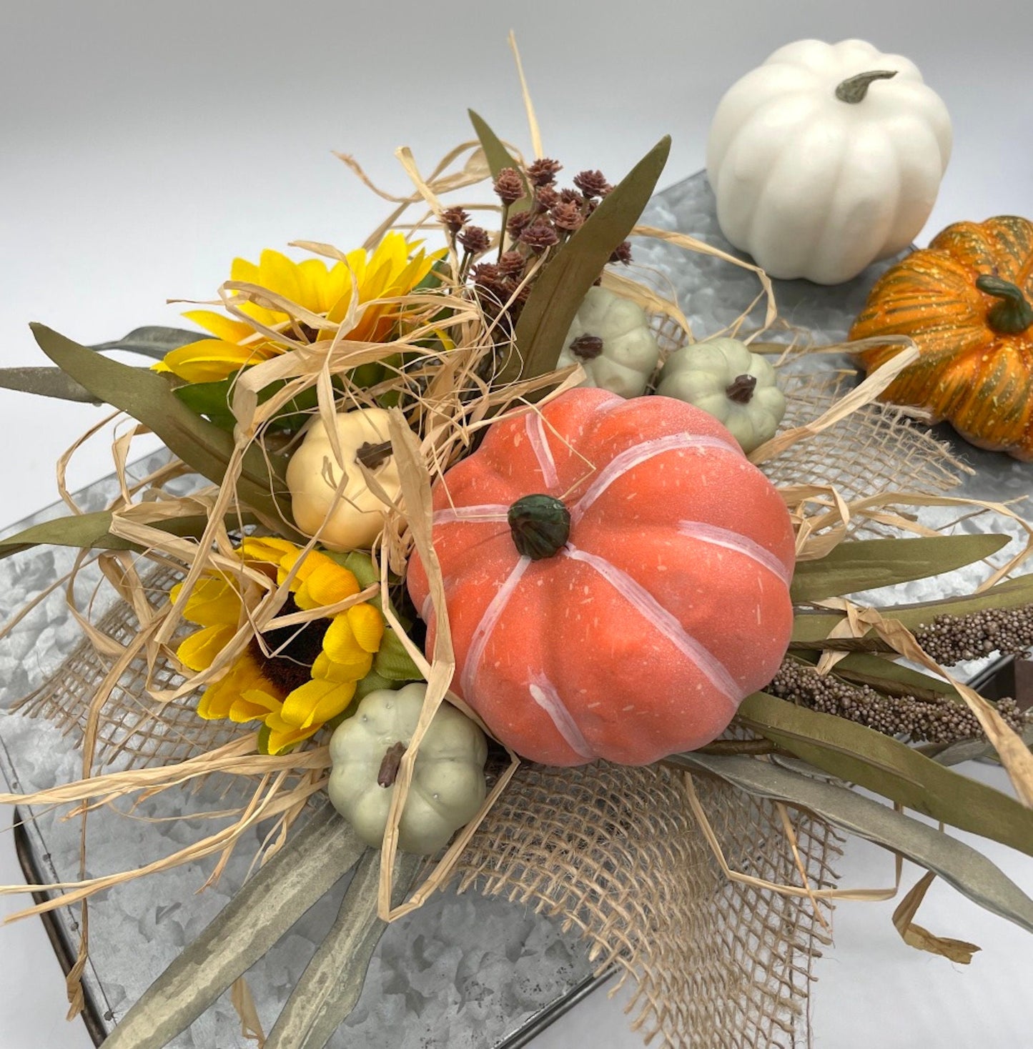 fall centerpiece with faux pumpkin, flowers and wheat stems in metal vase drawer shape