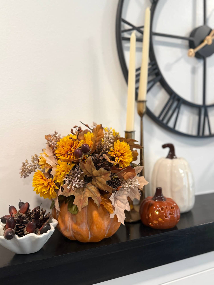 elegant fall floral arrangement on wooden orange pumpkin