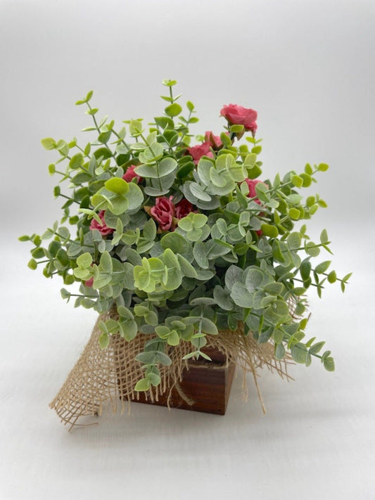 Farmhouse Floral Arrangement with faux eucalyptus and delicate smoked pink roses in wooden planter decorated with burlap and jute