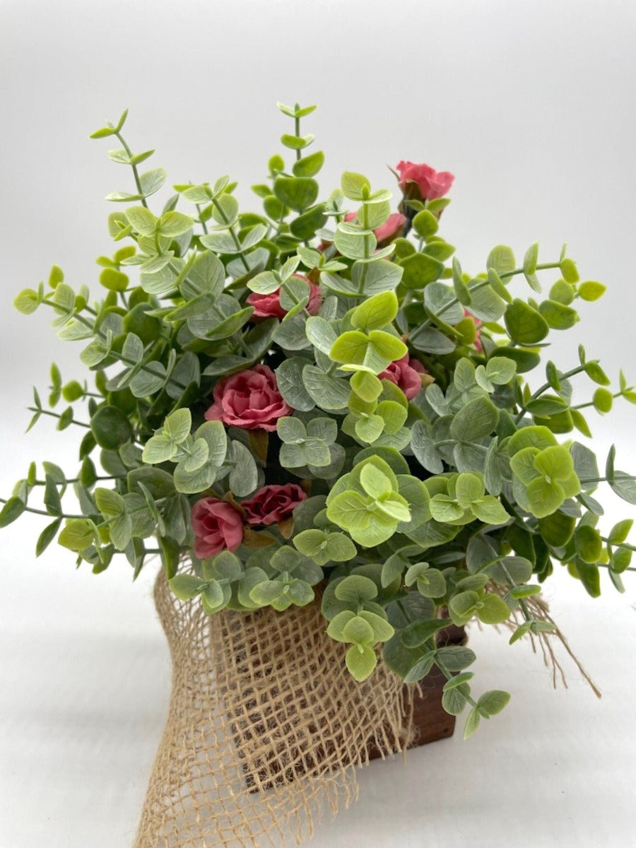 close up for Farmhouse Floral Arrangement with faux eucalyptus and smoked pink roses in wooden vase finished with burlap