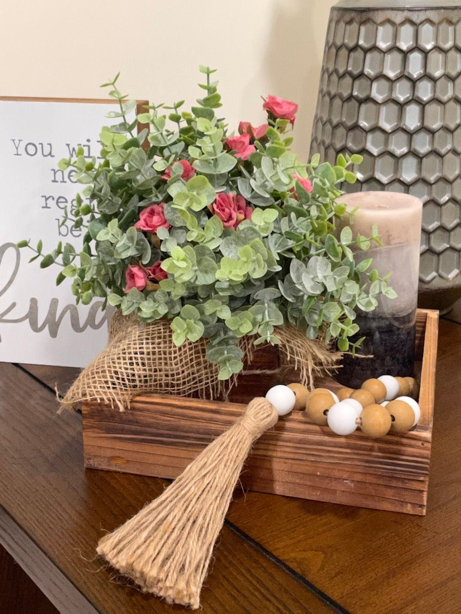 Farmhouse Tray Decor with faux eucalyptus arrangement, wooden bead garland and candle on wooden square tray