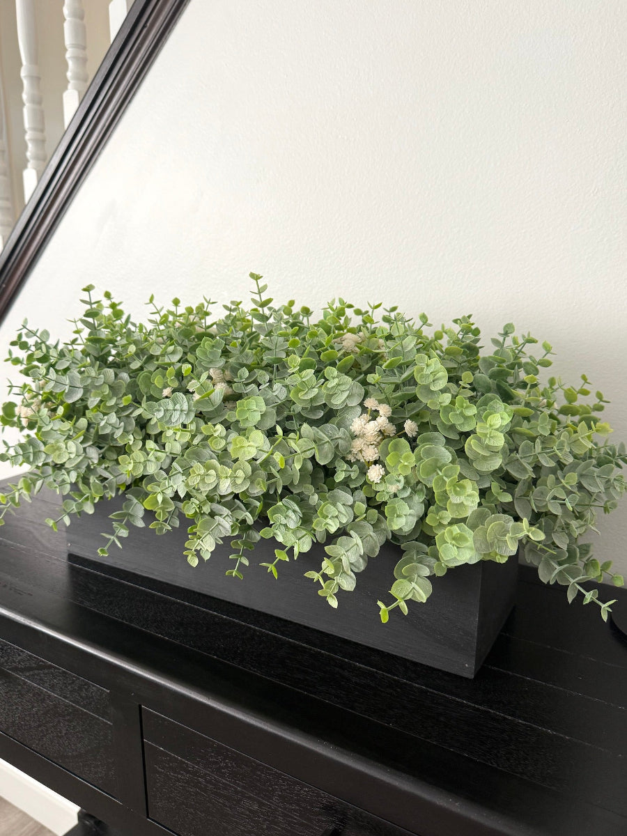 large realistic looking faux eucalyptus in black wooden planter 