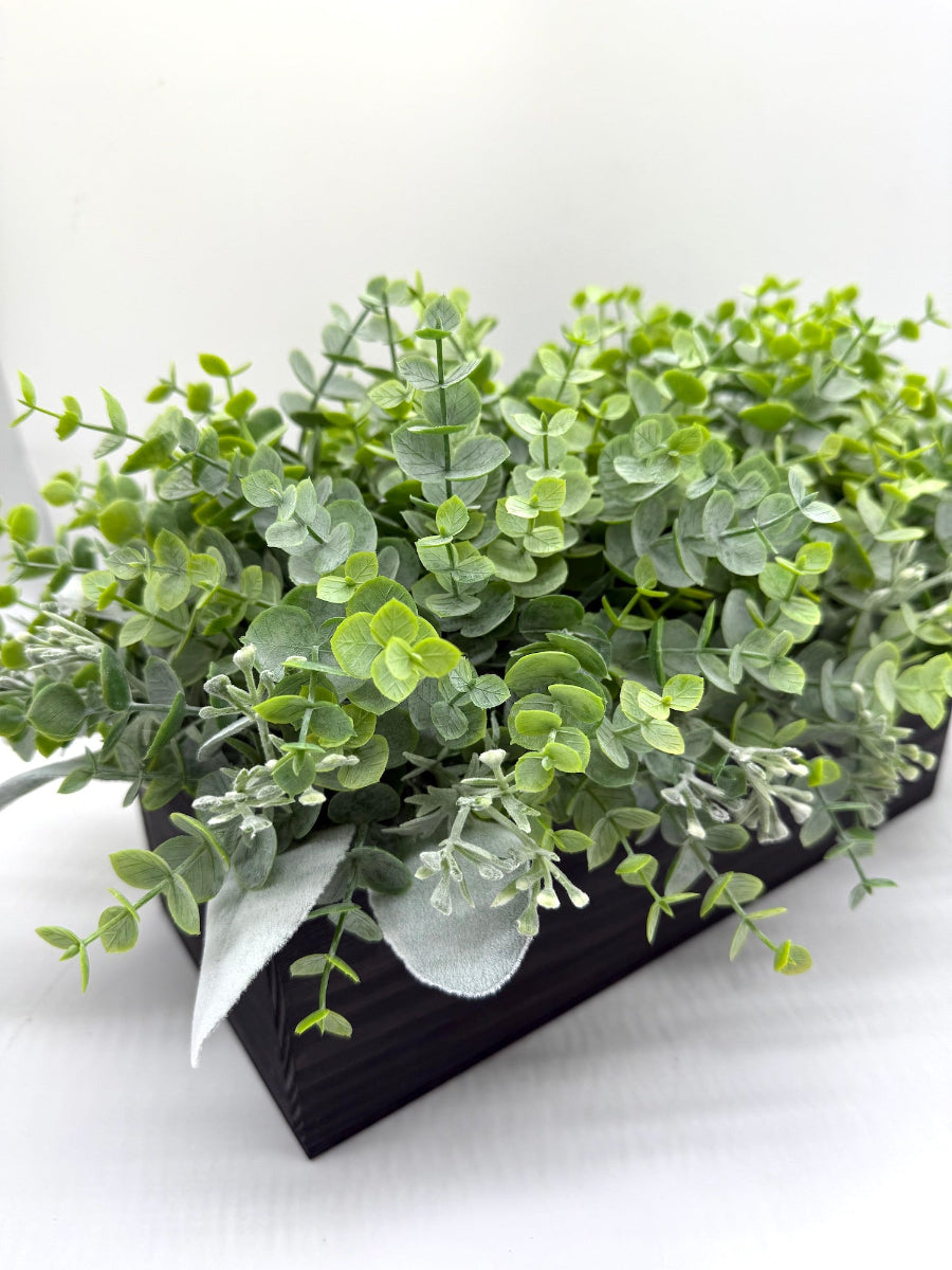 artificial greenery eucalyptus stems with lambs ear in black wooden vessel