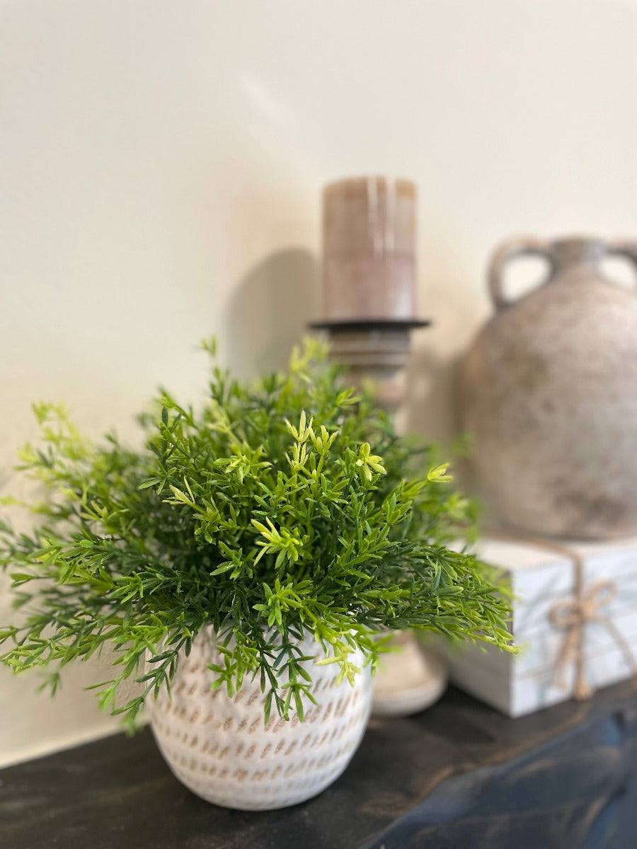 vivid green realistic looking faux plant in beige textured ceramic pot vase