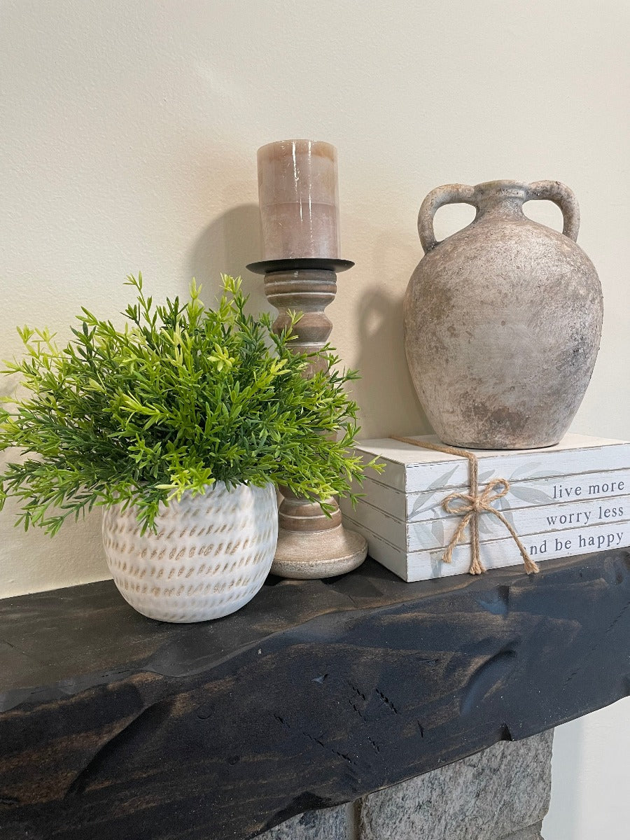 vivid green realistic looking faux plant in beige textured ceramic pot vase