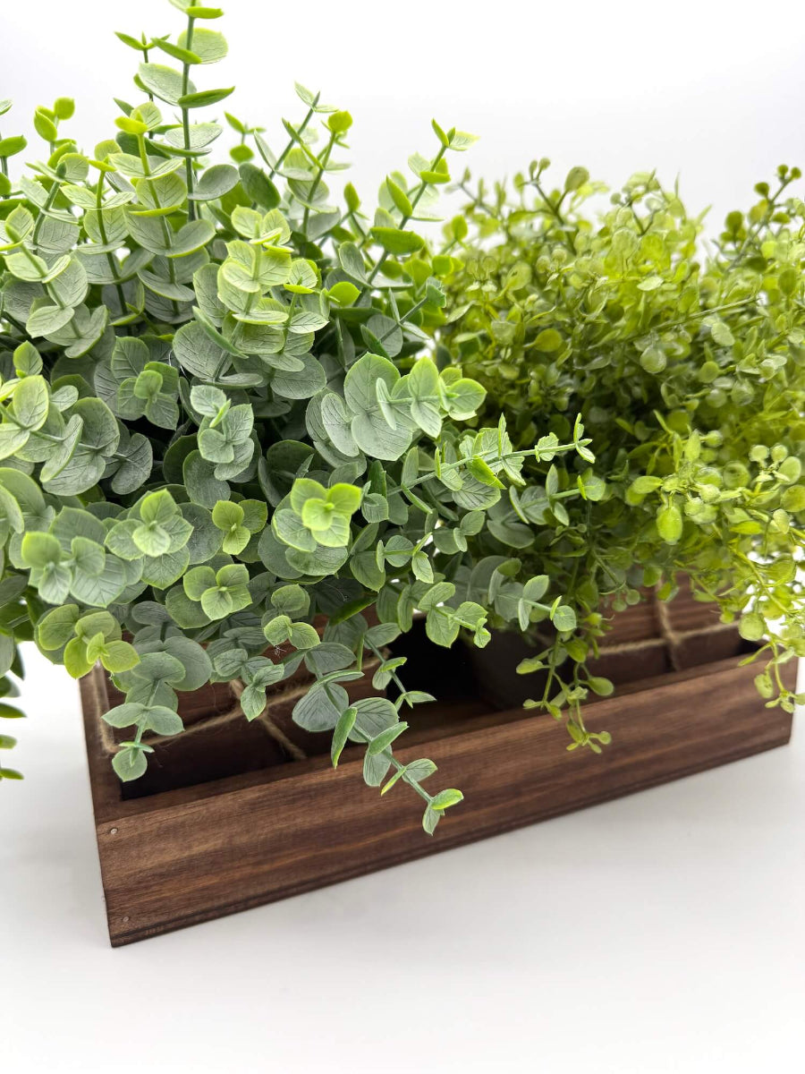 set of 2 faux plants -eucalyptus and vivid greenery in wooden planters o wooden tray stained in medium brown and decorated with jute