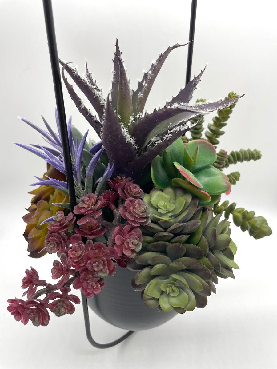 Hanging Faux Succulents-variety of realistic succulents in different shape and size from different shades of green to burgundy and purple in oval ganging metal planter on a chain