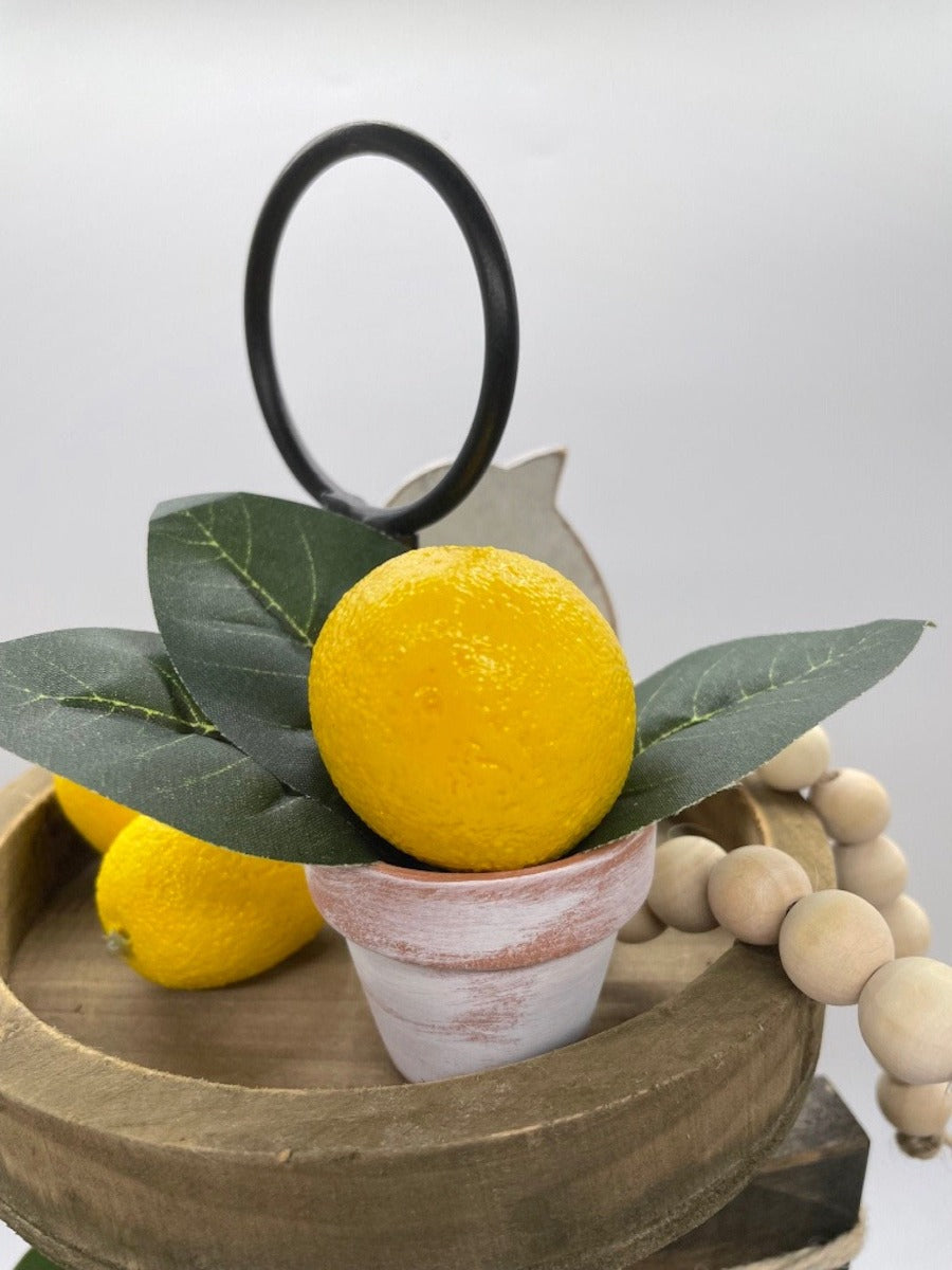 mini faux lemon with lemon leaf arrangement in clay pot touched with white pot
