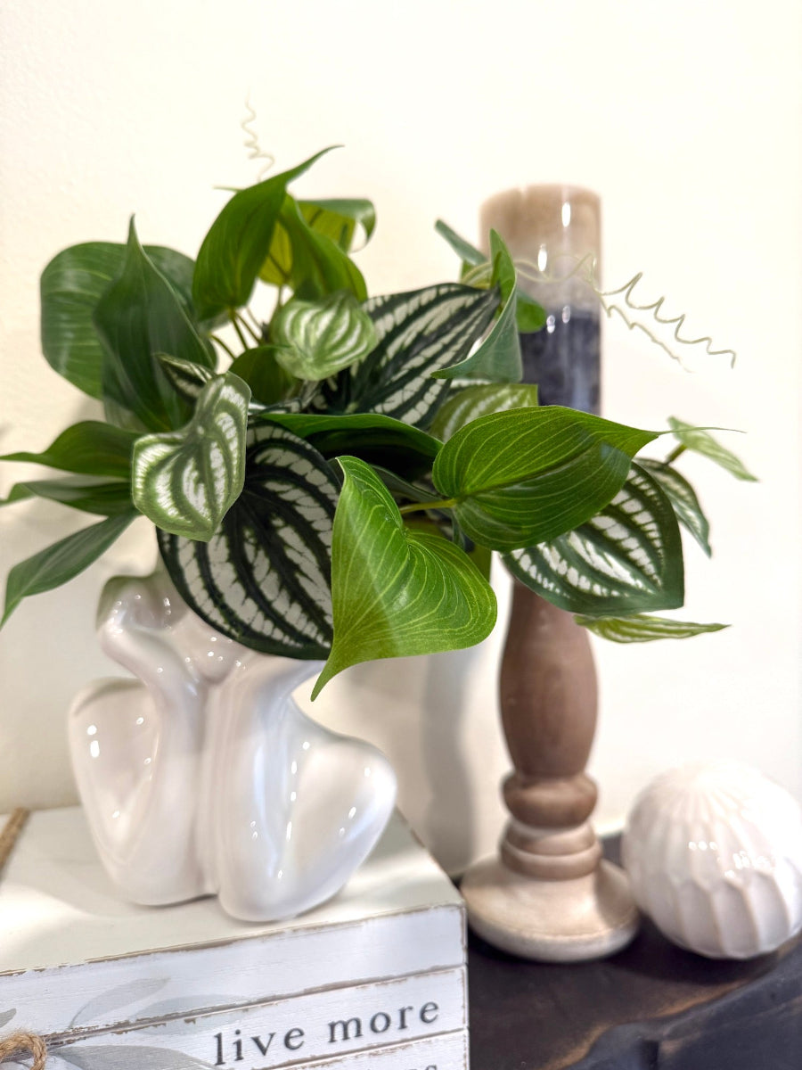 nearly natural pothos faux plant in elegant white ceramic vase in lady face hands shape