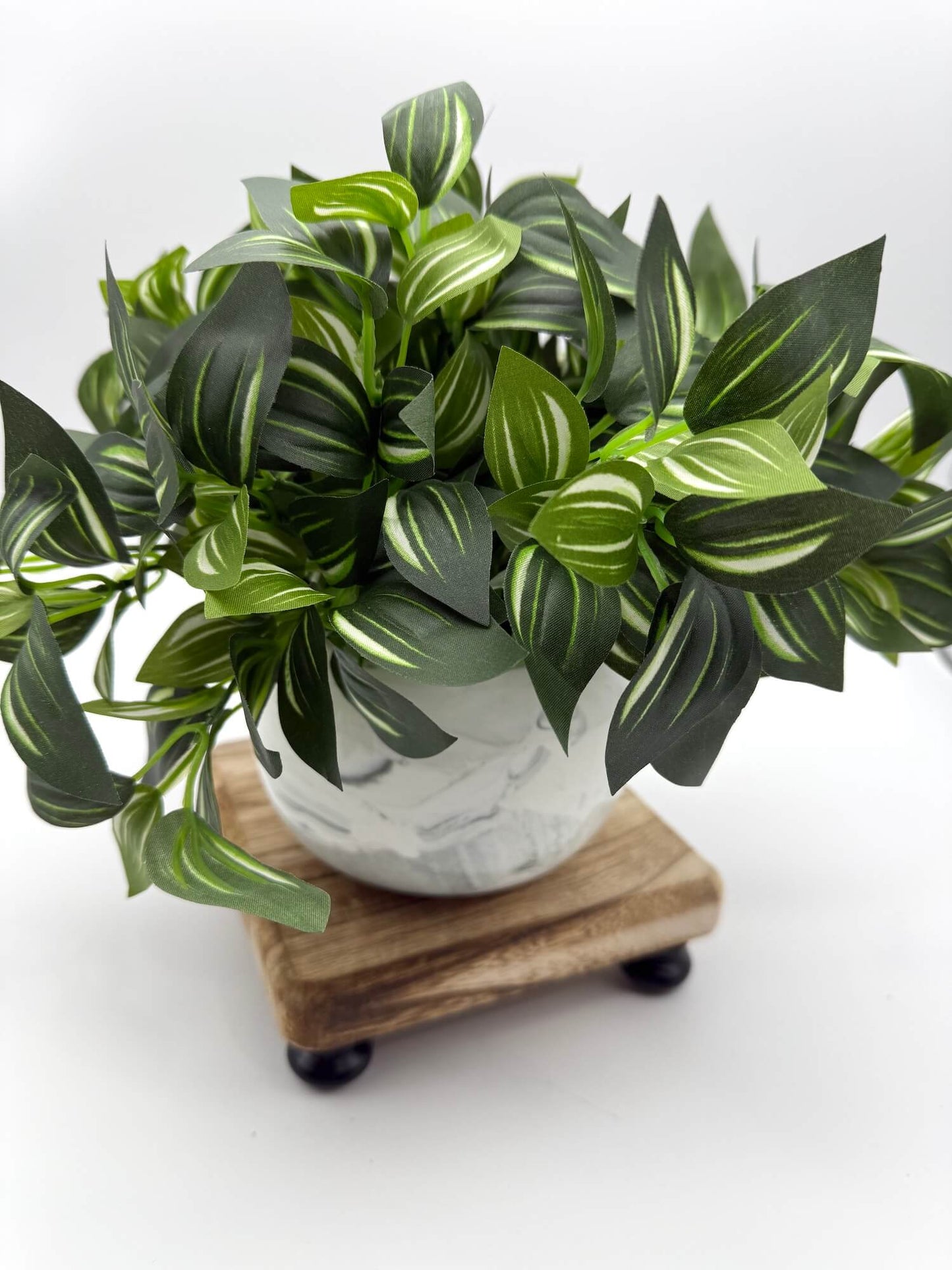 elegant green leaf silk plant in medium size in ceramic vase in white and gray