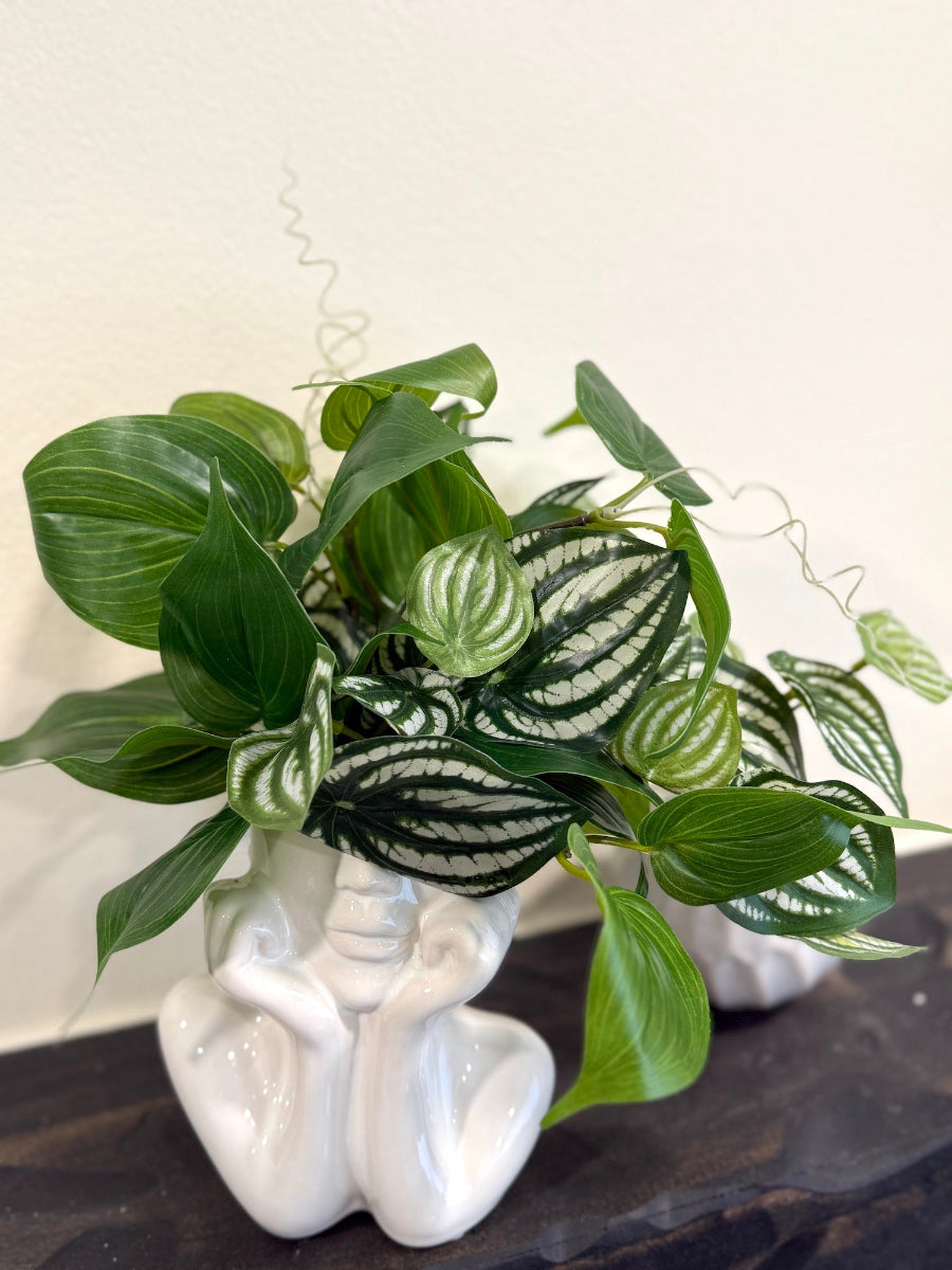 faux pothos plants in unique lady head white ceramic vase