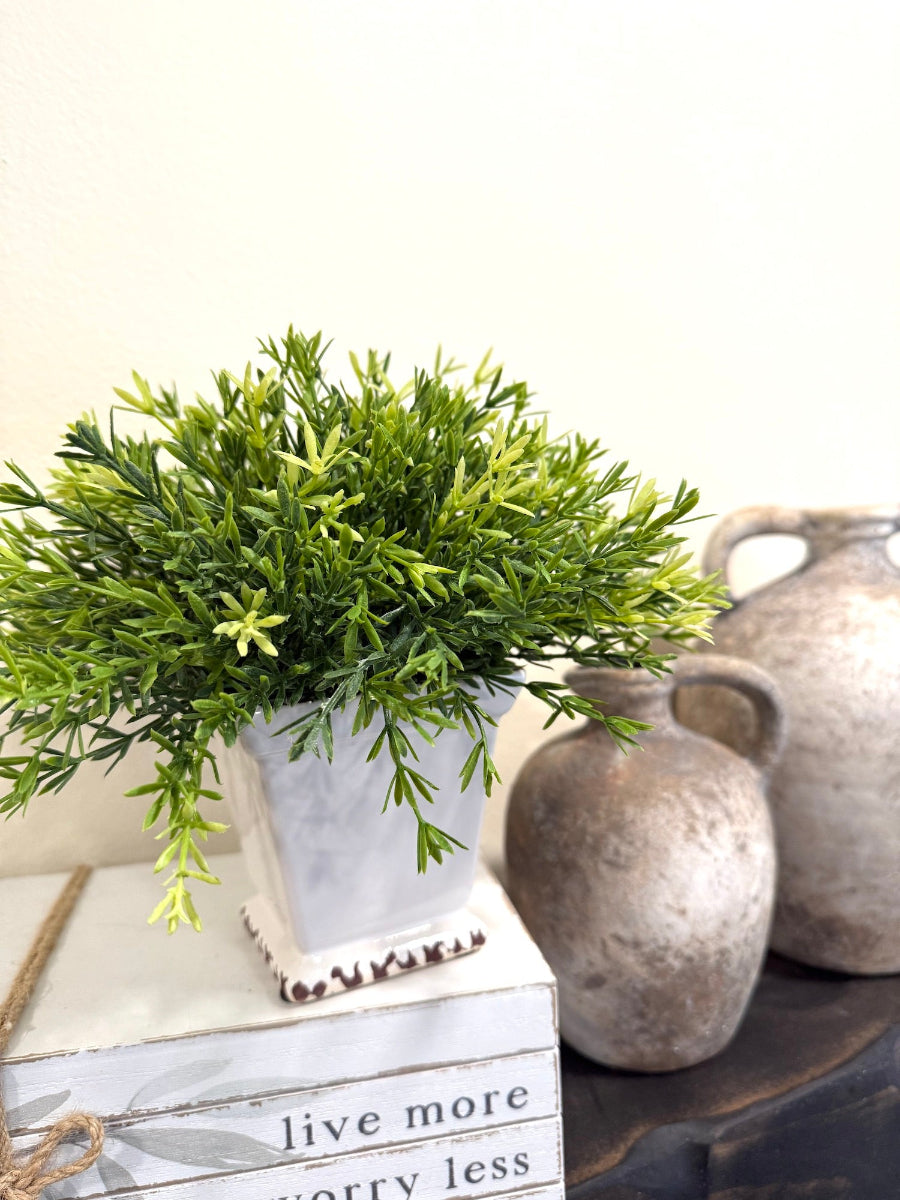 realistic looking faux plant in square ceramic white pot vase