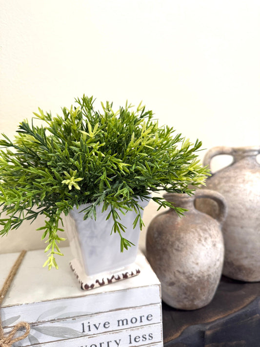 realistic looking faux plant in square ceramic white pot vase
