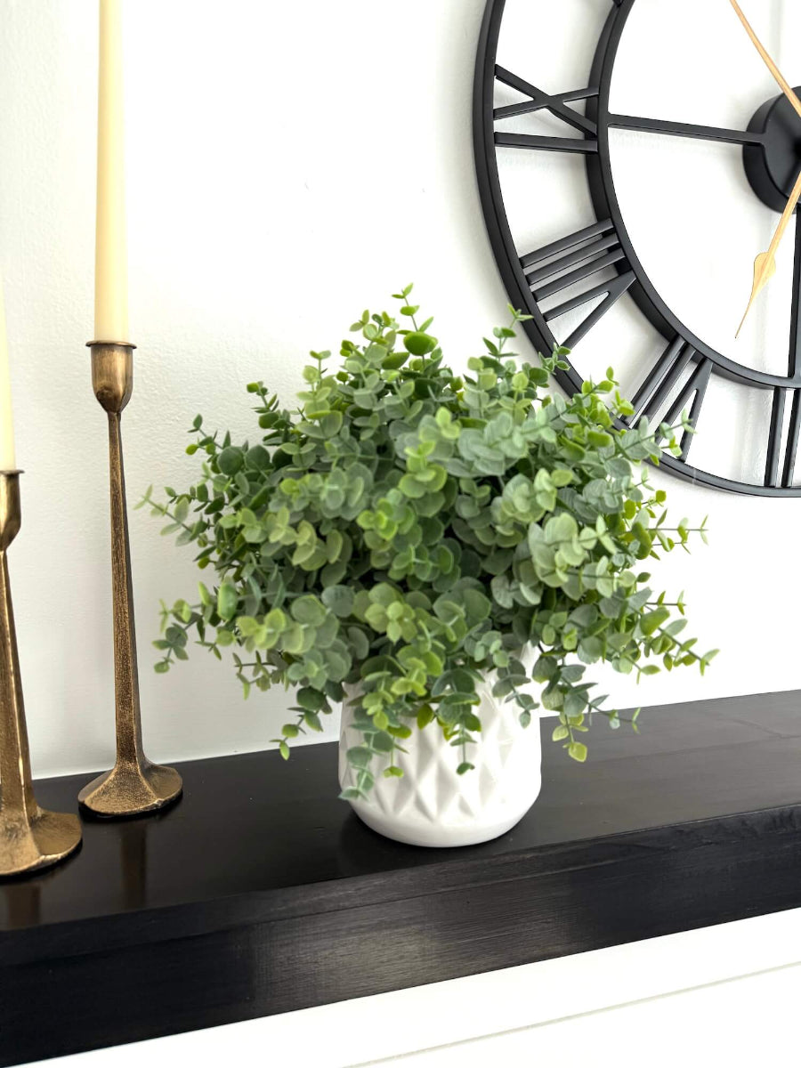 realistic faux eucalyptus plant in white ceramic pot vase of diamond pattern